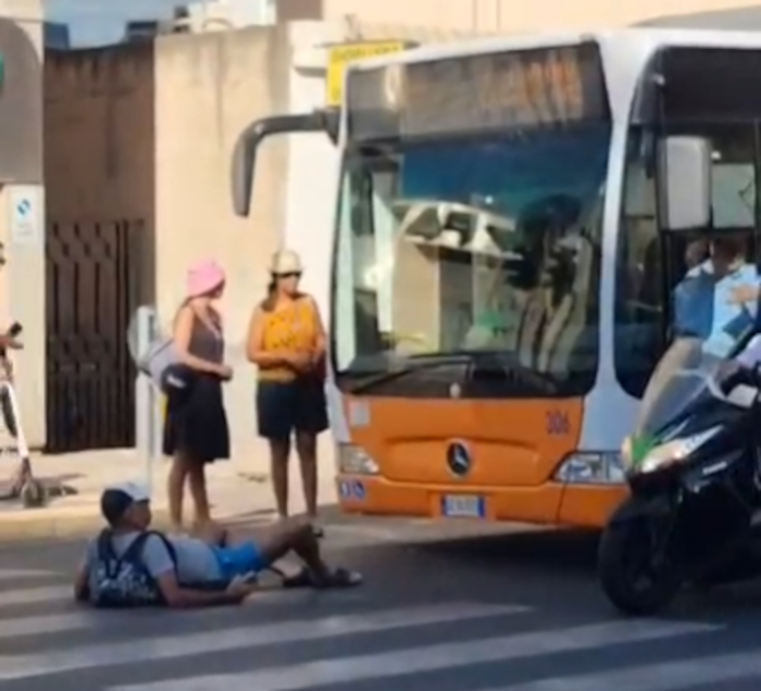 Cagliari, turista “impazzito” si sdraia in strada davanti al pullman e urla all’autista: “Fammi salire” (VIDEO)
